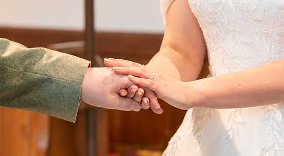 Bride and groom exchanging rings during a church wedding